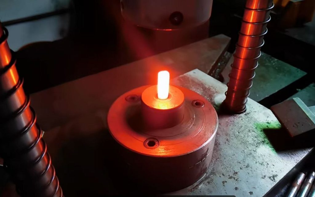 Induction-heated titanium billet in a hot-forging press