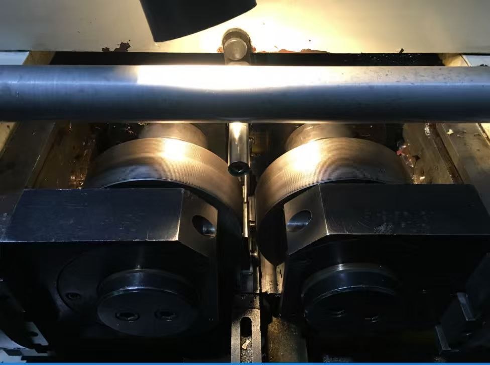 Thread-rolling dies forming a titanium bar